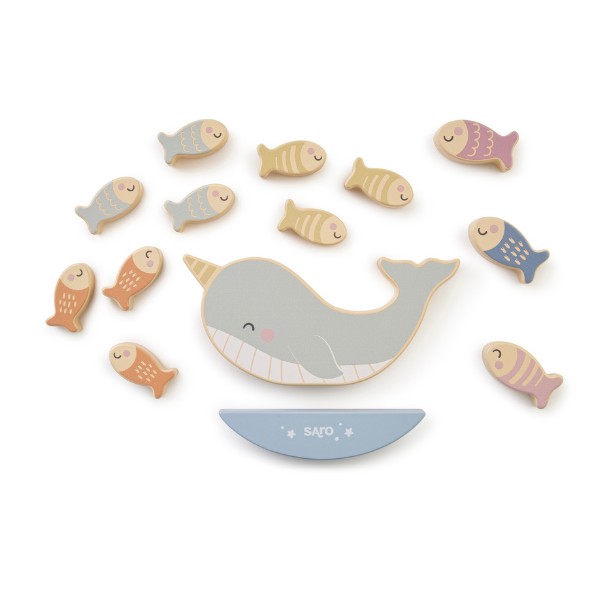 Wooden toy whale with fish on a white background