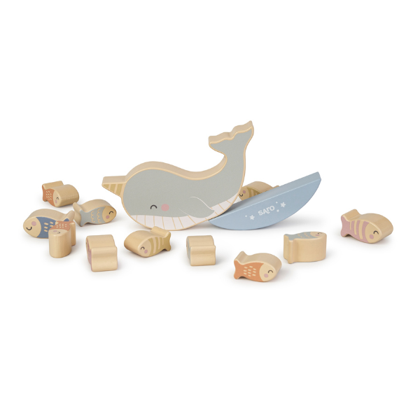 Wooden toy whale with fish pieces on a white background